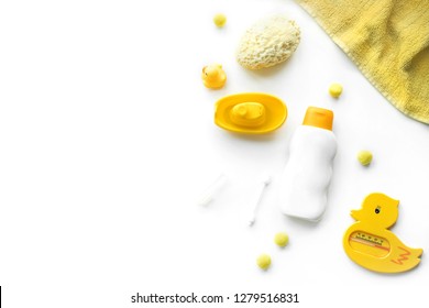 Baby Bath Products Flat Lay. Children Cosmetics Set: Rubber Duck, Towel, Shampoo, Soap, Scissors, Sponge, Hair And Tooth Brush Isolated On White Top View. Copy Space For Text