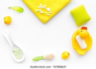 Baby Bath Set With Yellow Rubber Duck. Soap, Sponge, Brushes, Towel On White Background Top View Copyspace