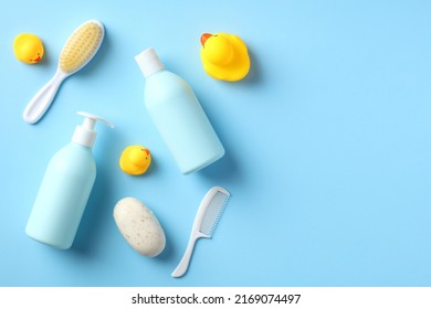 Baby Bathing Accessories And Shampoo Bottles On Blue Table. Flat Lay. Top View