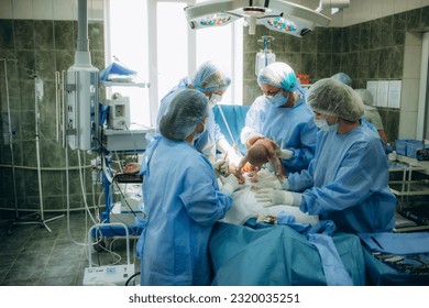 Baby being born via Caesarean Section coming out. Newborn child seconds and minutes after birth. New life, beginning, healthcare. - Powered by Shutterstock