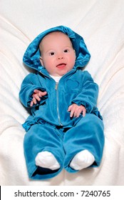 Baby In Blue - A 4 Month Old Baby Smiling And Happy In A Blue Velour Sweatsuit.