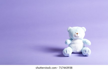 Baby Blue Child's Teddy Bear Stuffed Animal On A Purple Background