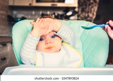 The Baby With Blue Eyes Does Not Want To Eat Vegetable Puree. The First Lure Of The Baby.