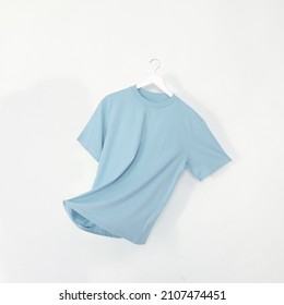 Baby Blue tshirt with hanger. Flying cotton T-shirt isolated on white background - Shutterstock ID 2107474451