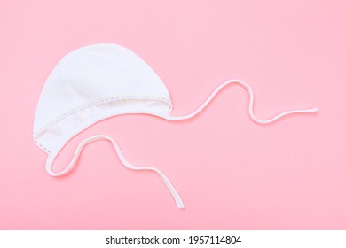 Baby Bonnet On Pastel Pink Background - Image 