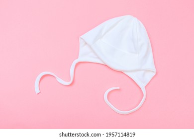 Baby Bonnet On Pastel Pink Background - Image 