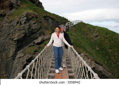 baby boomer couple on rope bridge - Powered by Shutterstock