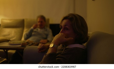 Baby Boomer Generation Watching Television At Living Room. Older Senior People Sitting On Couch Sofa