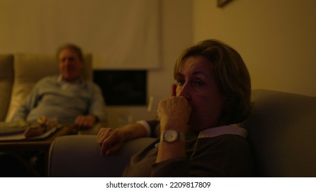 Baby Boomer Generation Watching Television At Living Room. Older Senior People Sitting On Couch Sofa