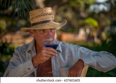 Baby Boomer Having A Drink In A Tropical Location; Vacation, Leisure, Lifestyle