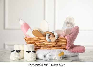 Baby booties and accessories on white marble table indoors - Shutterstock ID 1986035222