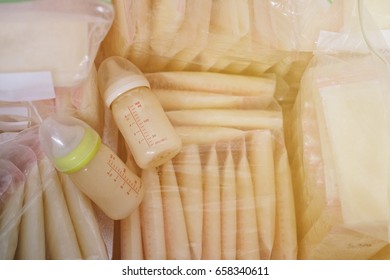 Baby Bottle With Milk And Frozen Breastmilk In Storage Bags In Refrigerator, Vintage Style