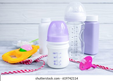 Baby Bottle With Milk On Wooden Background