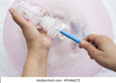 Baby Bottles It Was Clear That A Disinfectant In Water Cleaning Solution With Bottle Brush And Hand Holding Clean