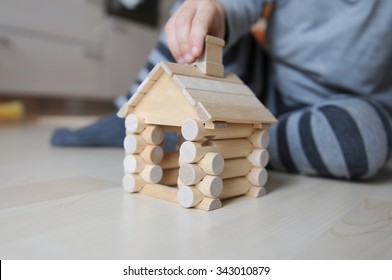 Baby Boy Building A Wooden House At Home Inside Horizontal Photo