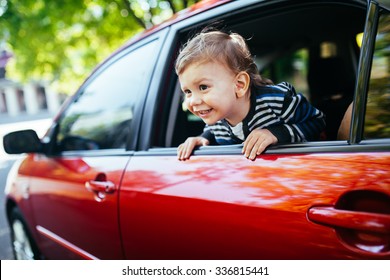 Baby Boy In The Car Looking Throw Window.