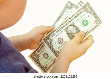 Baby Boy Counting Some Dollar Bills Isolated On White Light Background.top View Over Shoulder From Back.money Saving Financial Education Kids Family.one Two Dollars Banknote In Child Hands Isolated 