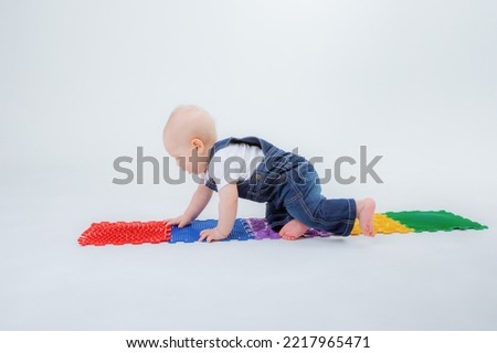 baby boy crawling orthopedic mat on white background