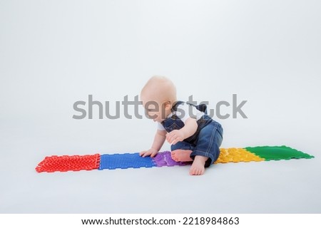 baby boy crawling orthopedic mat on white background