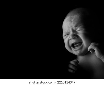 Baby Boy Crying, Studio Light Used On A Black Background.