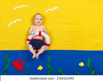 Baby Boy Is Diving Into Imaginary Pool. Dreaming About Sea, Adventures And Travel, Summer Vacation And Travel Concept. Funny Little Child Imitating Swimming And Jumping Into The Water At Home While