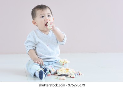 Baby boy eating cake 