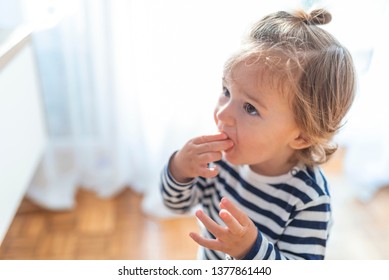 Baby Boy Eating Healthy Food. Baby With Banana.  Happy Kid Enjoy Eating Fresh Fruit. Healthy Food For Children Concept. Children Eat Bananas For Health. Healty Children's Snack