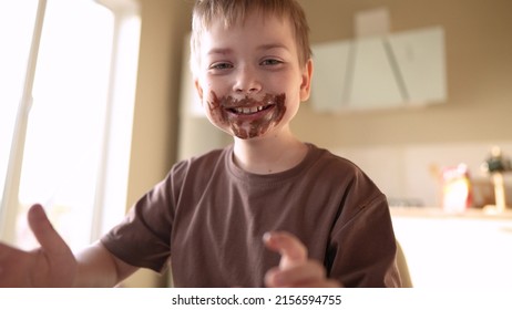 Baby Boy And Girl Eat Chocolate. Dirty Little Baby Kids In Lifestyle The Kitchen Eating Chocolate In The Morning. Happy Family Eating Sweets Kid Dream Concept. Baby Dirty Face Eating Chocolate Cocoa