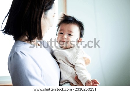baby boy held by mother