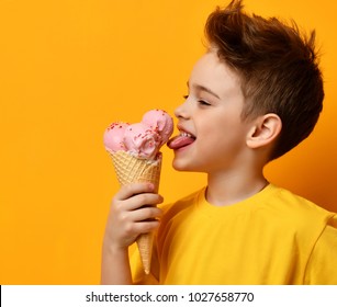 Baby Boy Kid Eating Licking Strawberry Ice Cream In Waffles Cone On Yellow Background With Free Text Copy Space