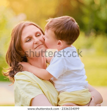 Similar – Image, Stock Photo Little boy kissing his mother on a field in summer