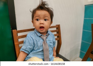 A Baby Boy With Messy Hair Wearing Smart Attire, With Many Facial Expressions