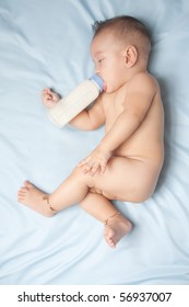 Baby boy and milk bottle