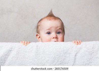 Baby Boy With A Mohawk Haircut Peeking Out Of The Crib