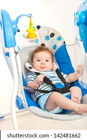 Baby Boy In A Musical Swing Home Against White Background