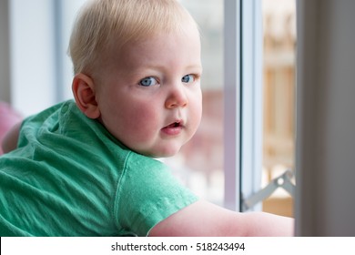 Baby Boy Opening A Window With Child Proof Locks Keeping Him Safe From Danger