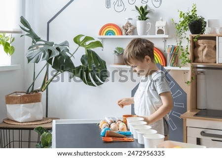 Baby boy playing cafe kitchen cashier payment counting use cash register at counter early development. Male child checking amount for buying sweet delicious bakery toy imitation at catering cuisine