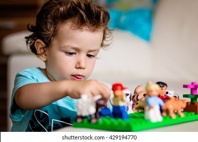 A Baby Boy Playing With Lego/ Construction Toy Blocks At Home. Kids Playing. Children At Day Care. Child And Toys.