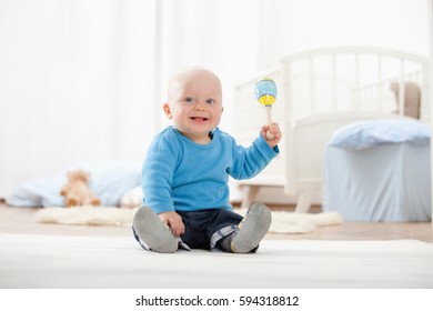 Baby Boy Playing With Rattle