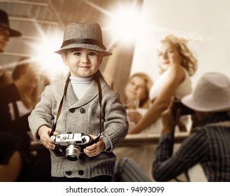 Baby Boy With Retro Camera Over Photo Shoot Background.