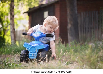 Baby Boy Is Riding A Toy Car Quad Bike.