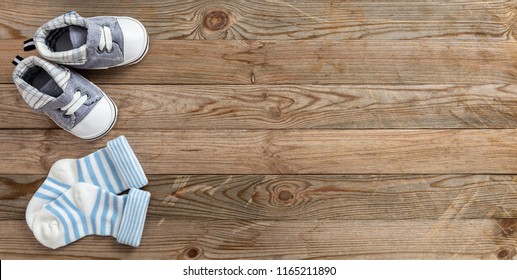 Baby boy shower concept on wooden background, copy space, top view