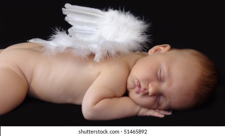 Baby Boy Sleeping With Angel Wings On His Back