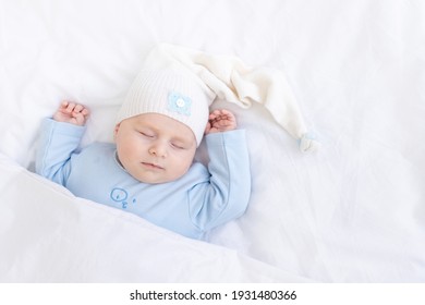 baby boy sleeping on the bed lying on his back under the blanket, healthy newborn sleep - Powered by Shutterstock