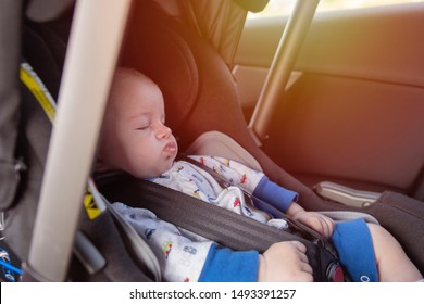 Baby Boy Sleeping In The Rear Facing Car Seat