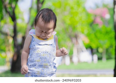 Baby Boy Sneezing while Walking in the Park, Child having Allergy and Itchy nose, Kid has Reflection or Hay Fever from Dust Mite, Allergies and Asthma Issues in Children concept. - Powered by Shutterstock