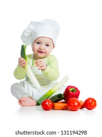 baby boy wearing a chef hat with healthy  food vegetables