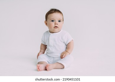 baby boy in a white bodysuit crawling on a white background - Shutterstock ID 2190451101