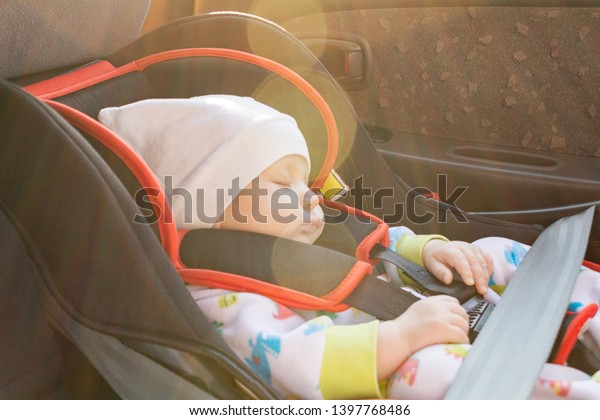 baby in the car, the\
concept of safe transportation of children in the car seat, seat\
belts, safe movement