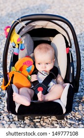  Baby In The Car Seat On The Beach On A Sunny Day